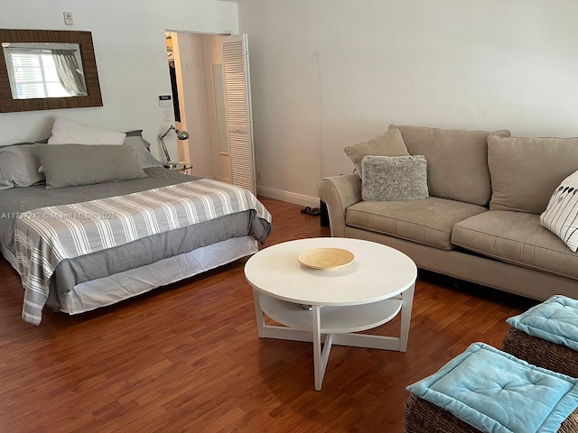 bedroom with dark hardwood / wood-style flooring