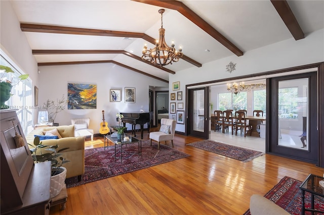 living room with an inviting chandelier, hardwood / wood-style floors, and vaulted ceiling with beams