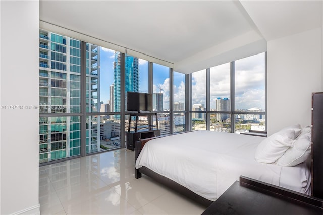 tiled bedroom featuring expansive windows