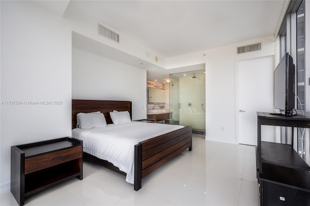 bedroom with connected bathroom and light tile patterned flooring