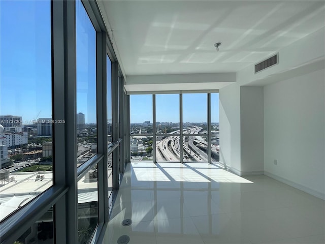 spare room with a wall of windows