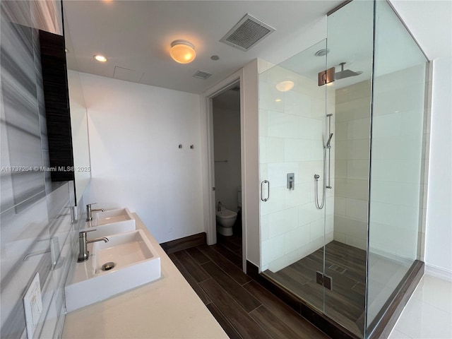 bathroom featuring vanity and an enclosed shower