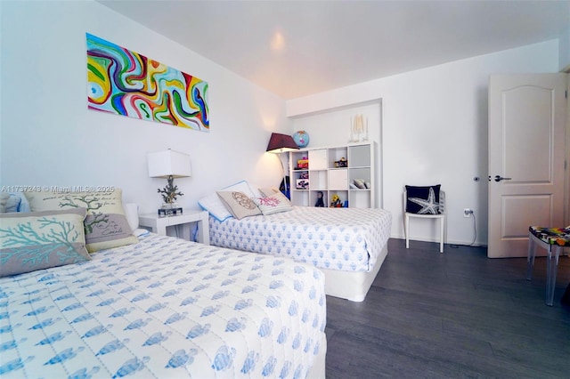 bedroom with dark hardwood / wood-style floors