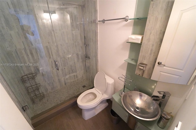 bathroom with toilet, wood-type flooring, vanity, and walk in shower