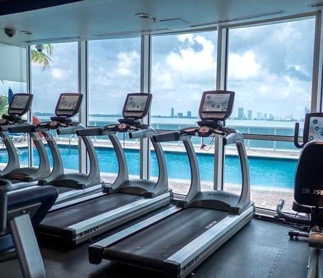 workout area featuring a water view