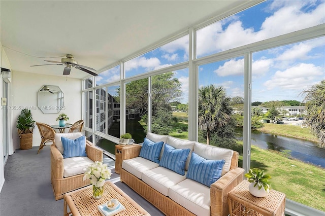 sunroom / solarium with a water view, a wealth of natural light, and ceiling fan