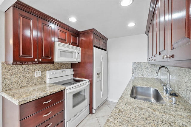 kitchen with sink, light stone counters, light tile patterned floors, white appliances, and backsplash