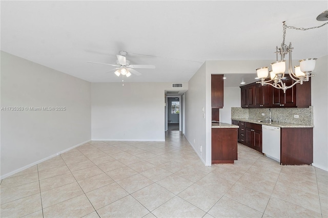 kitchen featuring hanging light fixtures, light tile patterned floors, dishwasher, ceiling fan with notable chandelier, and decorative backsplash