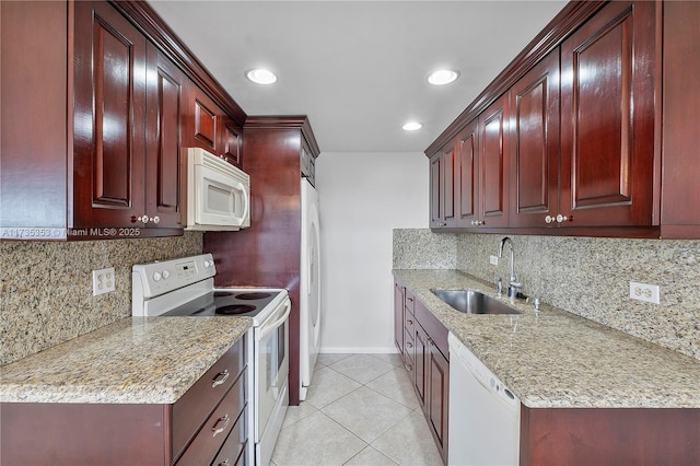 kitchen with sink, tasteful backsplash, light tile patterned floors, white appliances, and light stone countertops