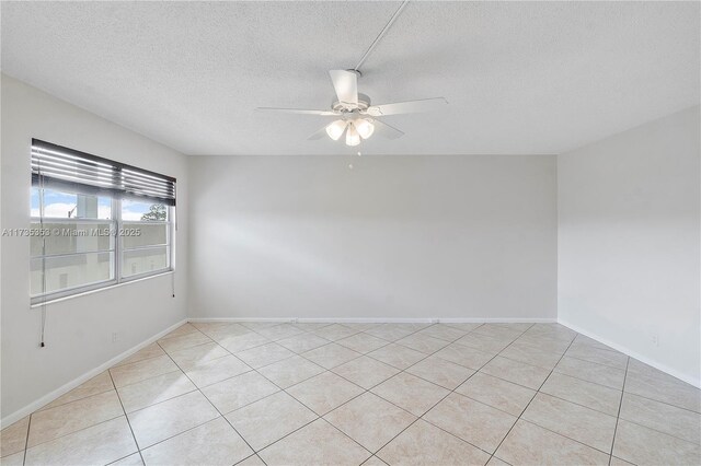 unfurnished room featuring ceiling fan and a textured ceiling