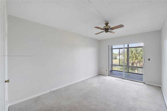 carpeted spare room featuring ceiling fan and a textured ceiling