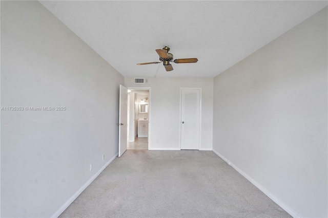 spare room with ceiling fan and a textured ceiling