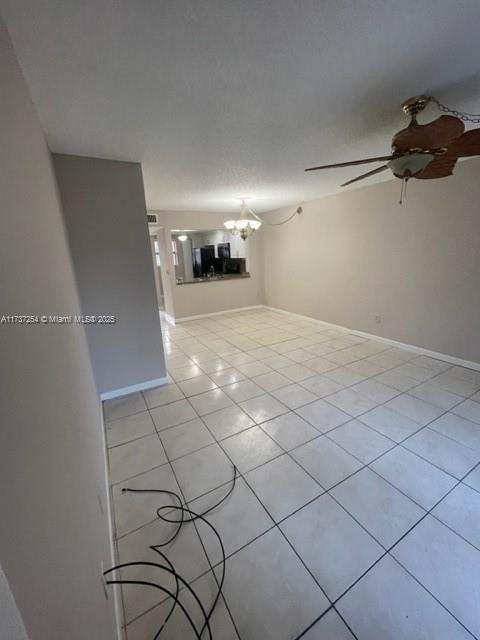 20810 NE 8th Ct Unit 104-18, Miami, FL 33179 - tiled empty room with ceiling fan with notable chandelier