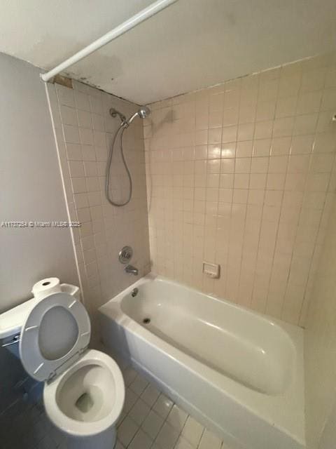 20810 NE 8th Ct Unit 104-18, Miami, FL 33179 - bathroom featuring tiled shower / bath combo, tile patterned floors, and toilet