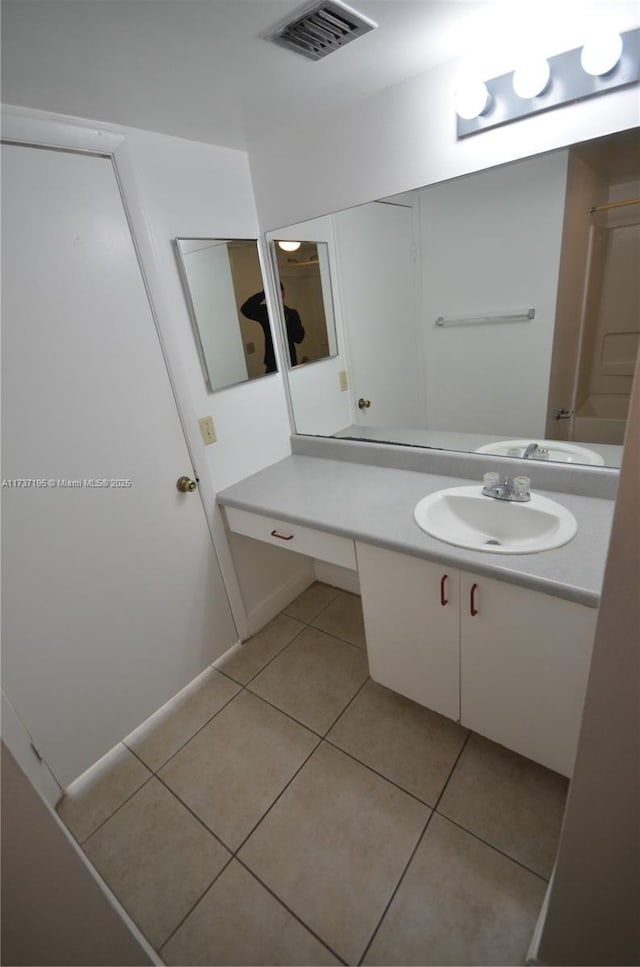 bathroom featuring tile patterned flooring, visible vents, and vanity