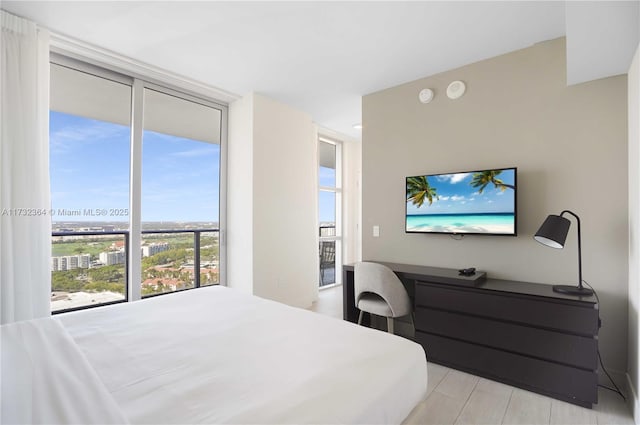 bedroom with built in desk and a wall of windows