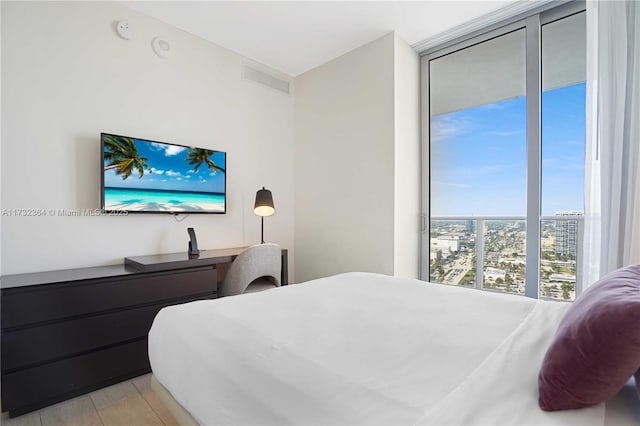 bedroom with floor to ceiling windows