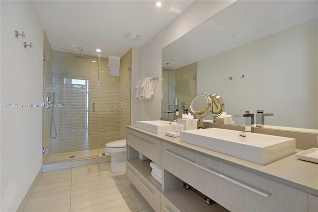 bathroom featuring vanity, tile patterned flooring, toilet, and walk in shower