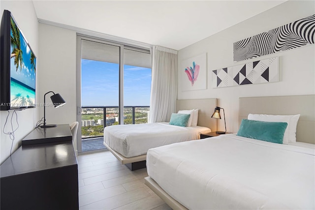 bedroom featuring floor to ceiling windows and access to outside