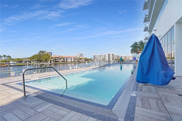 view of pool with a water view