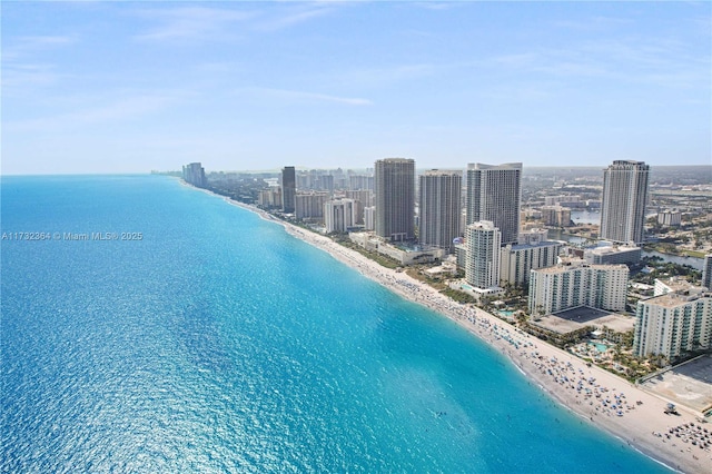 birds eye view of property featuring a beach view and a water view