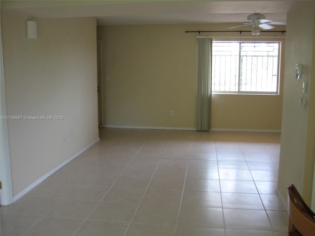 spare room featuring light tile patterned flooring and ceiling fan