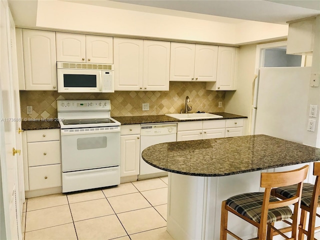 kitchen with white cabinetry, sink, and white appliances