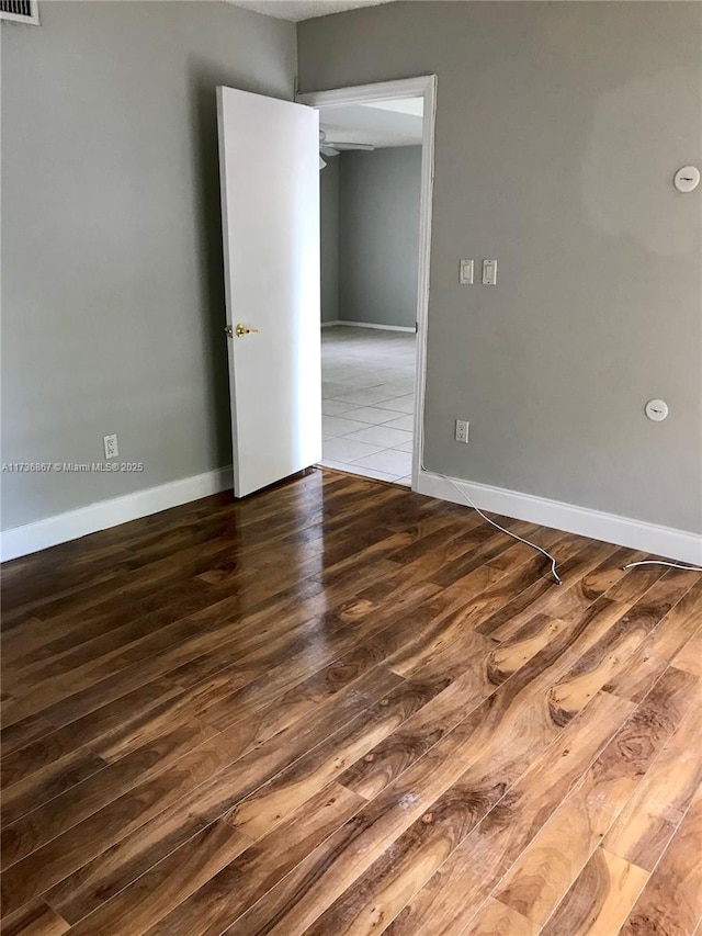 unfurnished room with hardwood / wood-style flooring