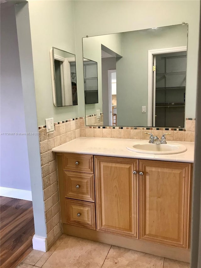 bathroom with tile patterned floors, vanity, and tile walls