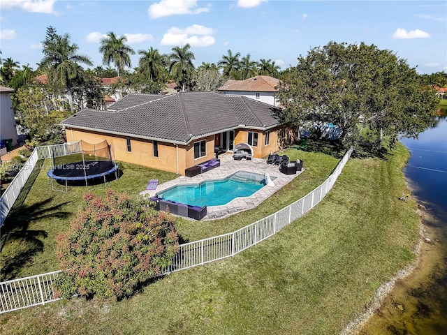 view of pool with a trampoline, a yard, outdoor lounge area, and a patio