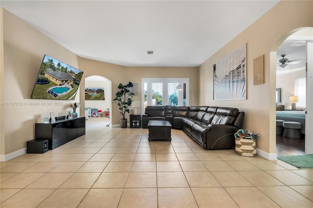 tiled living room with ceiling fan