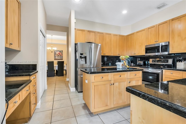 kitchen with dark stone countertops, decorative backsplash, and appliances with stainless steel finishes