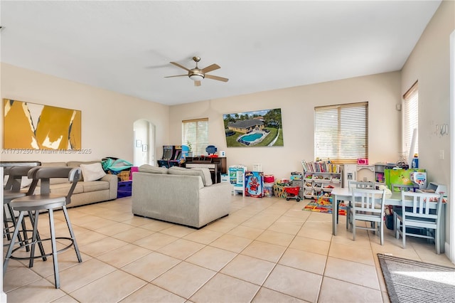 tiled living room with ceiling fan