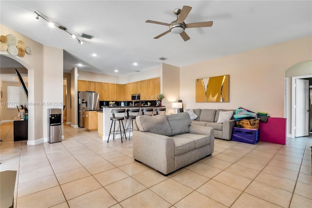 tiled living room featuring ceiling fan