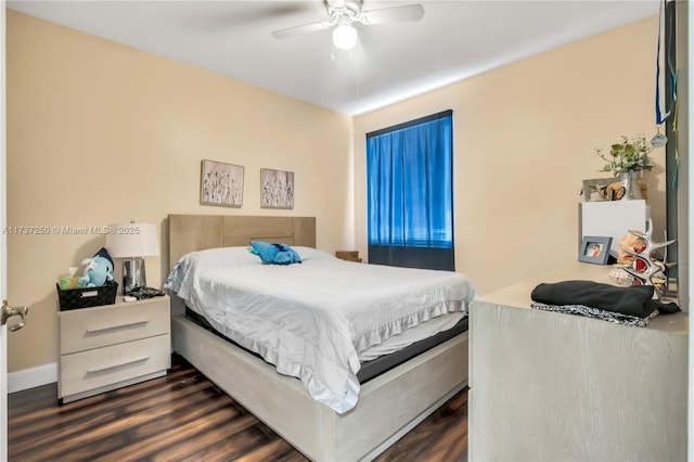 bedroom with dark hardwood / wood-style floors and ceiling fan