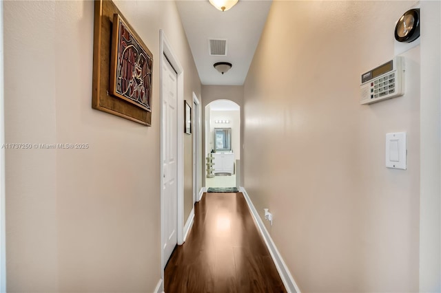 corridor with dark wood-type flooring