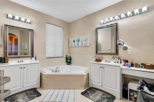 bathroom featuring vanity, tiled bath, and tile patterned flooring