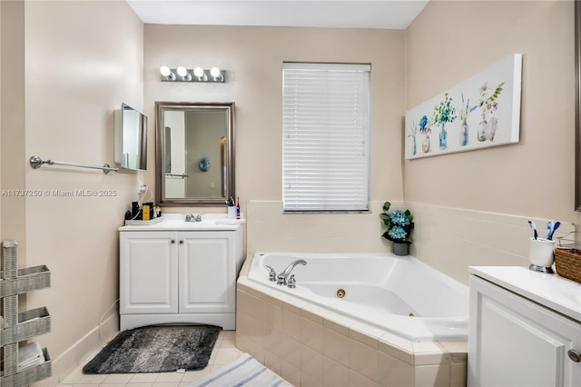 bathroom with vanity, tiled tub, and tile patterned flooring