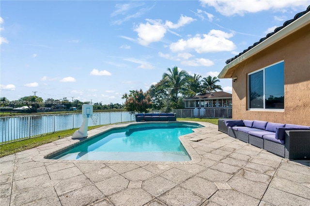 view of pool with a patio, a water view, and an outdoor hangout area