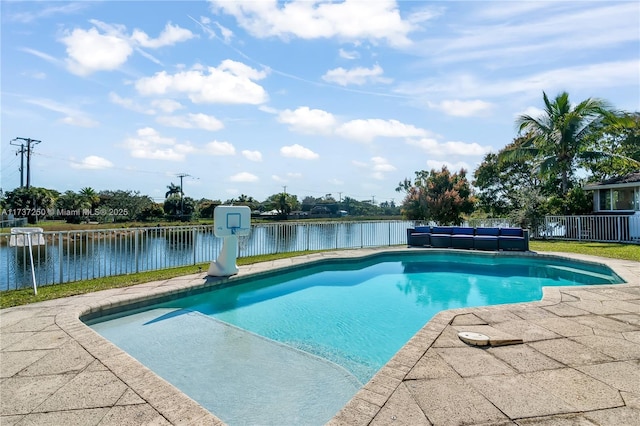 view of swimming pool featuring a water view, an outdoor living space, and a patio area