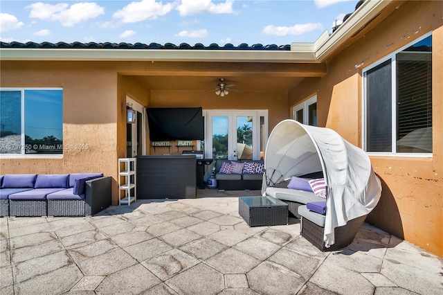 view of patio with an outdoor living space and ceiling fan