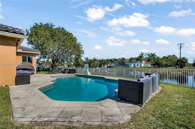 view of swimming pool featuring an outdoor living space, a patio, and a water view