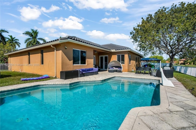 view of pool with an outdoor living space and a patio