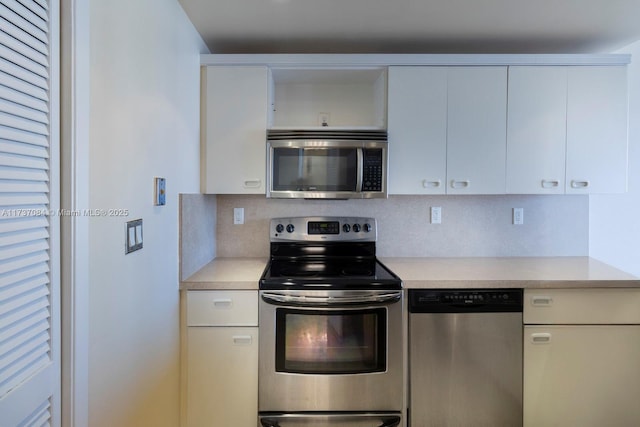 kitchen featuring appliances with stainless steel finishes, decorative backsplash, and white cabinets