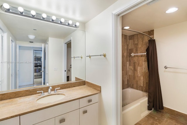 bathroom featuring vanity and shower / bath combo with shower curtain