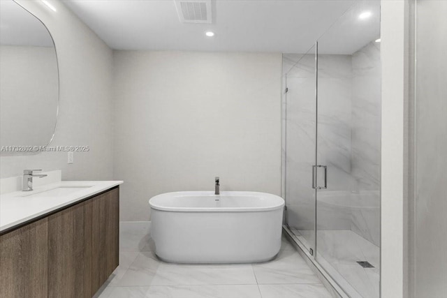 bathroom with vanity and independent shower and bath