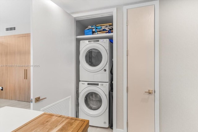 laundry area with stacked washer and dryer