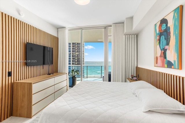 bedroom featuring access to outside and floor to ceiling windows