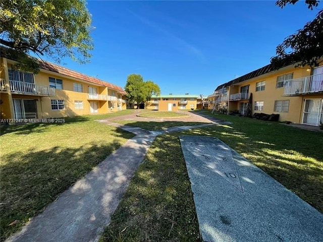 view of home's community with a yard