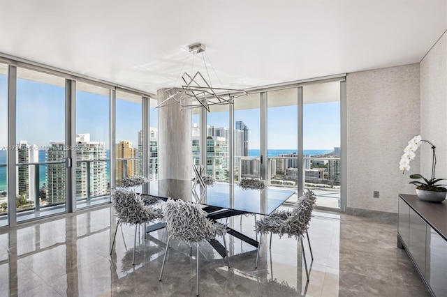 sunroom / solarium with a water view and an inviting chandelier